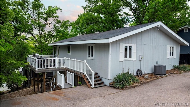back of house with a deck, central air condition unit, and stairs