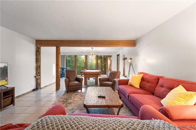 tiled living area with pool table and a textured ceiling