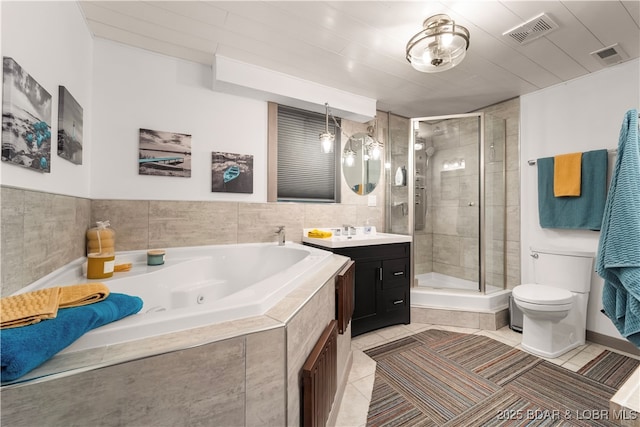 bathroom with a stall shower, a whirlpool tub, toilet, vanity, and tile patterned flooring