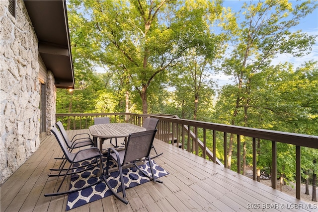 wooden terrace with outdoor dining area