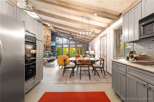 kitchen with black appliances, gray cabinets, backsplash, and light tile patterned floors