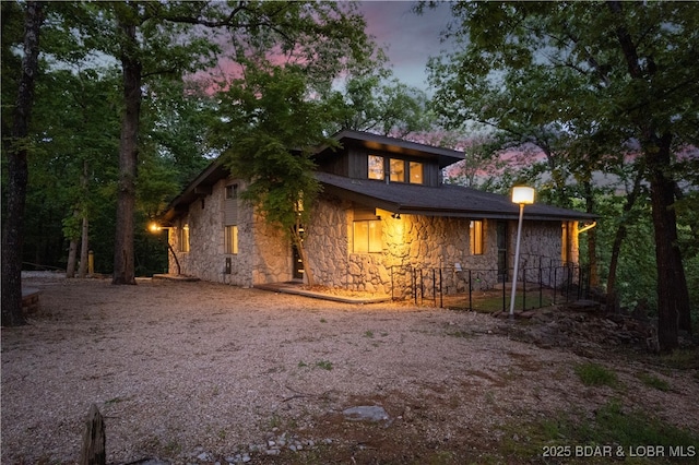 rear view of property with stone siding