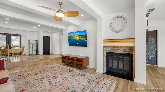 19 Casa Blanca Ct Unit 219, Lake Ozark, MO 65049 - living area featuring recessed lighting, a ceiling fan, a stone fireplace, wood finished floors, and baseboards
