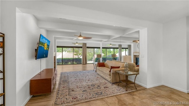 19 Casa Blanca Ct Unit 219, Lake Ozark, MO 65049 - living room featuring plenty of natural light, ceiling fan, baseboards, and beam ceiling