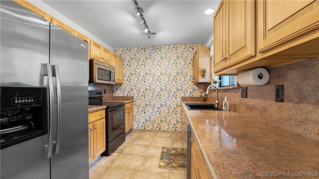 19 Casa Blanca Ct Unit 219, Lake Ozark, MO 65049 - kitchen featuring stainless steel appliances, a sink, wallpapered walls, and tasteful backsplash