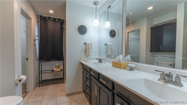 19 Casa Blanca Ct Unit 219, Lake Ozark, MO 65049 - full bathroom with toilet, double vanity, recessed lighting, tile patterned floors, and baseboards
