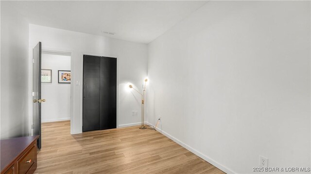 19 Casa Blanca Ct Unit 219, Lake Ozark, MO 65049 - unfurnished room with light wood-type flooring and baseboards