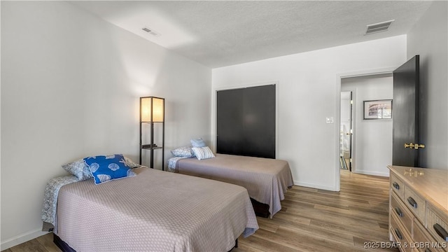 19 Casa Blanca Ct Unit 219, Lake Ozark, MO 65049 - bedroom with wood finished floors and baseboards