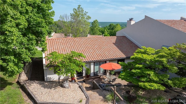 19 Casa Blanca Ct Unit 219, Lake Ozark, MO 65049 - rear view of house with a tile roof, stucco siding, and a patio area