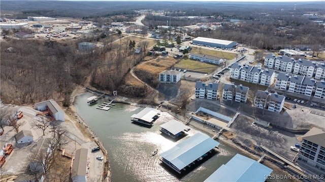 aerial overview of property's location with a nearby body of water and apartment complex / building
