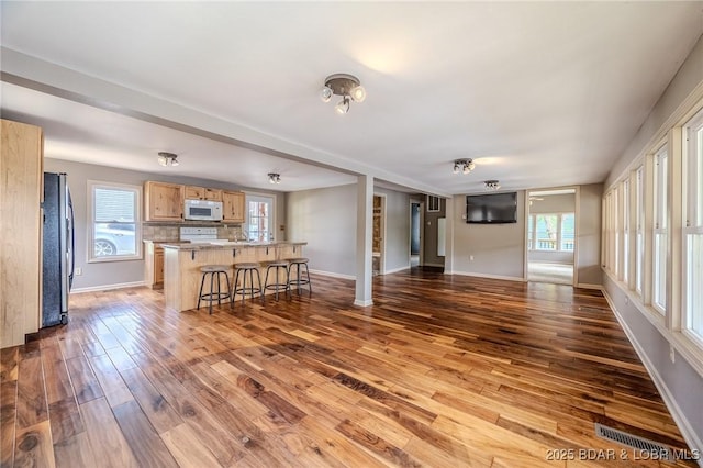 living room featuring light wood-style flooring and baseboards