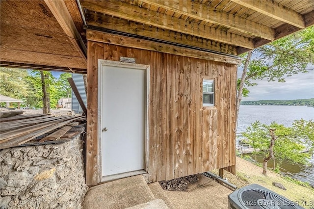 view of outbuilding featuring a water view and cooling unit