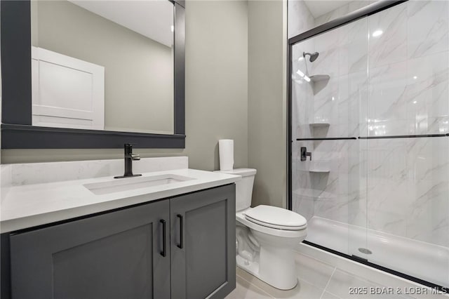 bathroom featuring a marble finish shower, toilet, and vanity