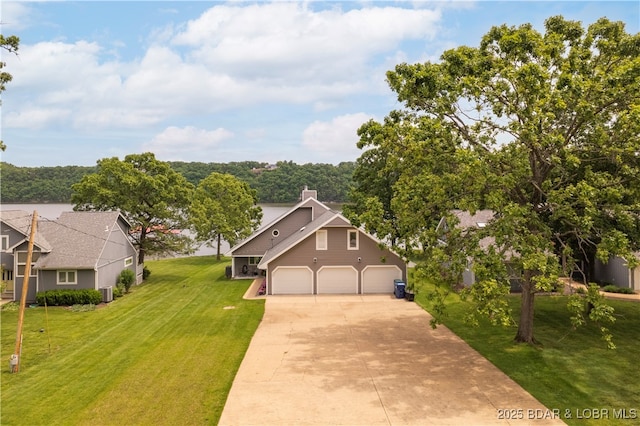 view of front of property with concrete driveway, a front lawn, central air condition unit, and an attached garage