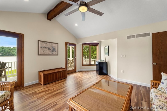 living area featuring plenty of natural light, a ceiling fan, light wood finished floors, recessed lighting, and baseboards