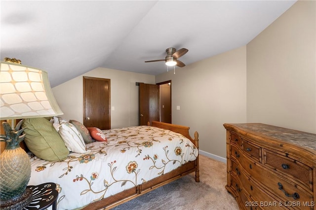 carpeted bedroom with vaulted ceiling, ceiling fan, and baseboards