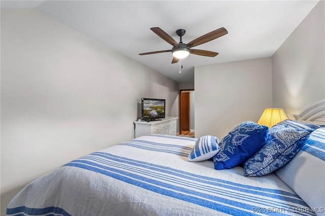 bedroom with a ceiling fan and lofted ceiling