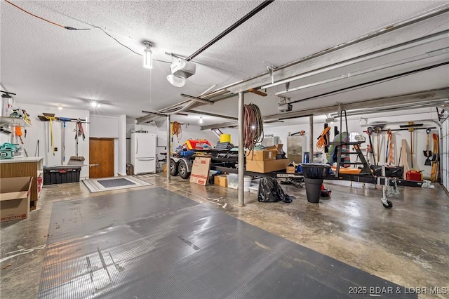 garage with freestanding refrigerator and a garage door opener