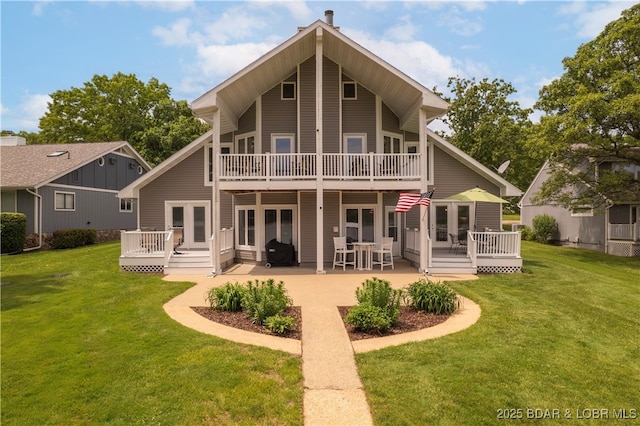 back of house featuring a deck, a yard, and a patio area