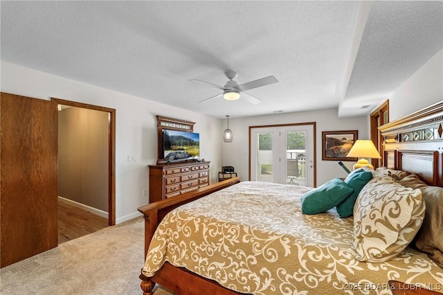 carpeted bedroom with access to exterior, a textured ceiling, a ceiling fan, and baseboards