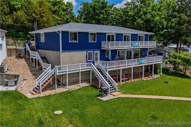 rear view of house featuring stairs, a wooden deck, a balcony, a yard, and central AC unit