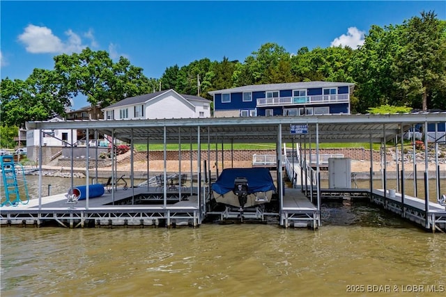 dock area featuring boat lift and a water view