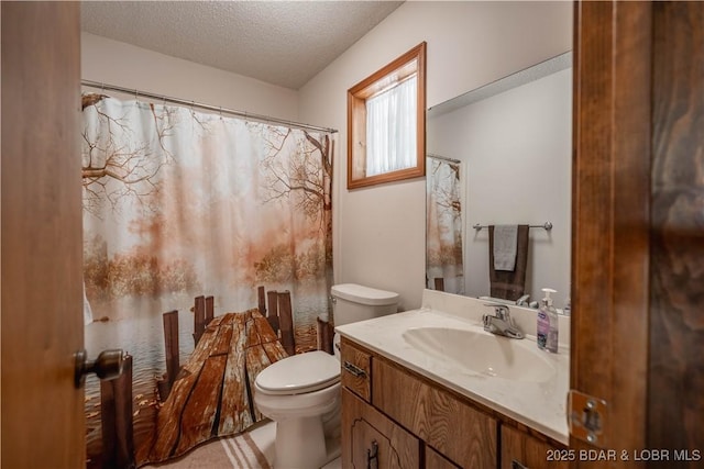 full bath featuring toilet, a textured ceiling, vanity, and a shower with curtain