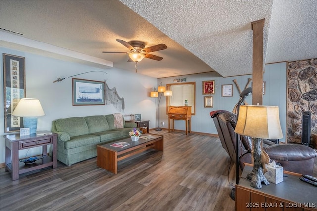 living room with a textured ceiling, ceiling fan, wood finished floors, and baseboards