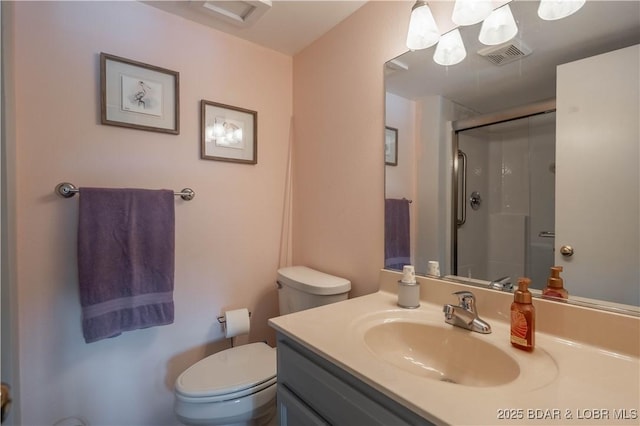 full bath featuring a stall shower, toilet, and vanity