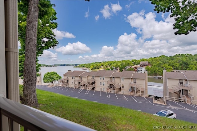 view of yard with a water view and a balcony