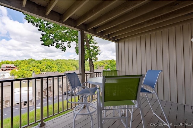 wooden terrace featuring outdoor dining space