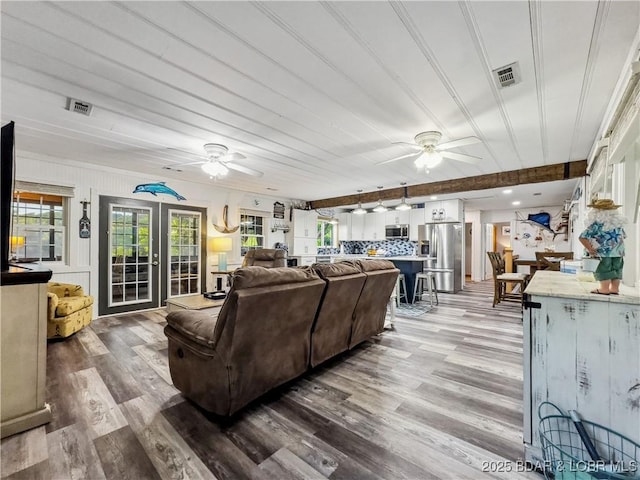 living room with ceiling fan, wood finished floors, and french doors