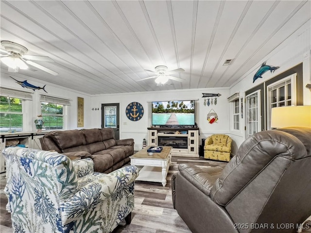 living room featuring a ceiling fan and wood finished floors