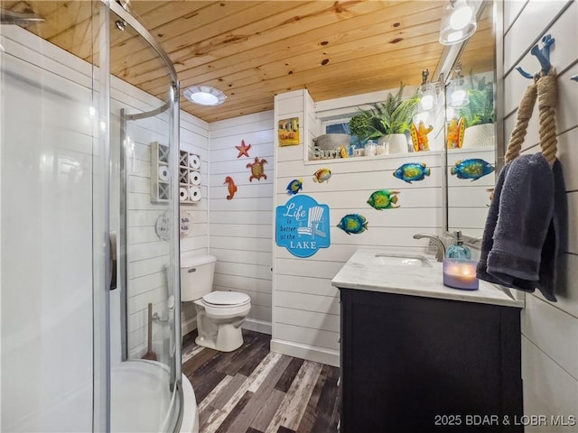 full bath featuring wooden ceiling, wood finished floors, vanity, a stall shower, and toilet