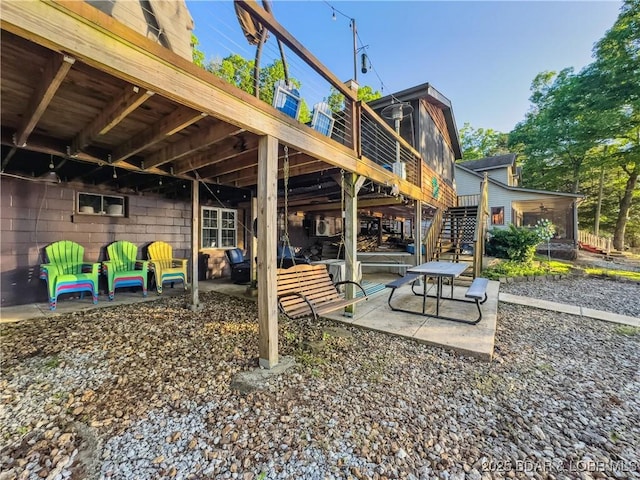view of patio / terrace with stairway and a deck