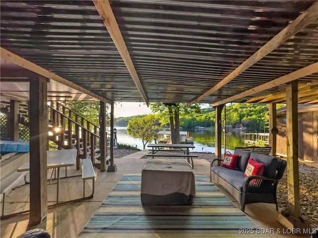 view of patio featuring stairs, a water view, and an outdoor hangout area
