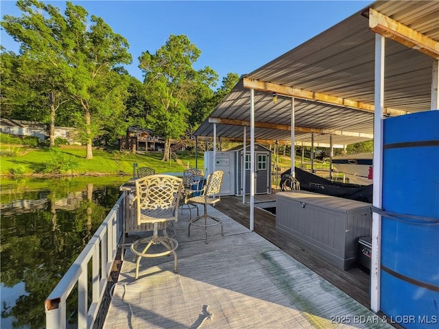 dock with outdoor dining area and a deck with water view