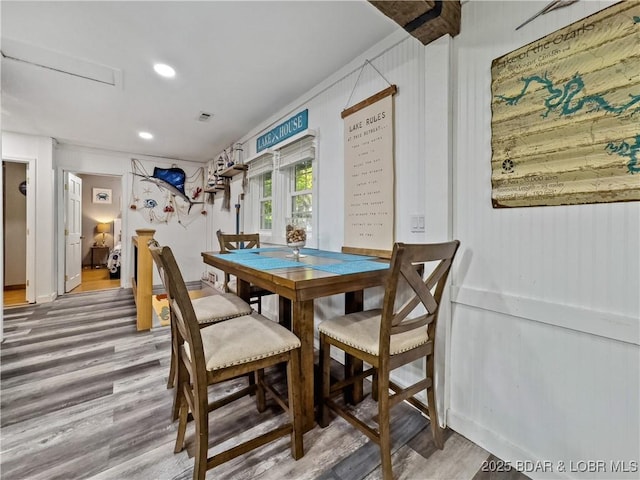dining area with wood finished floors and recessed lighting