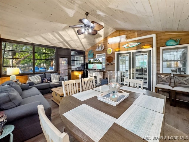dining room featuring wooden walls, vaulted ceiling, healthy amount of natural light, wooden ceiling, and ceiling fan
