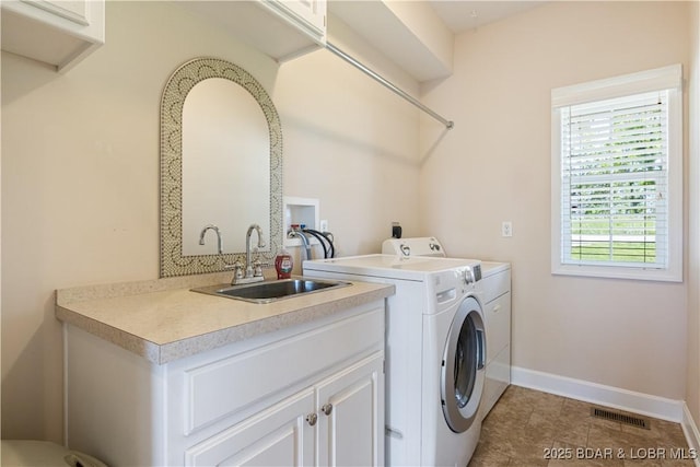 22714 Lake Ridge Dr, Warsaw, MO 65355 - laundry area featuring washing machine and clothes dryer, cabinet space, baseboards, and light tile patterned floors
