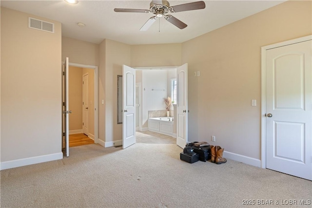 22714 Lake Ridge Dr, Warsaw, MO 65355 - unfurnished bedroom with light colored carpet, baseboards, connected bathroom, and ceiling fan