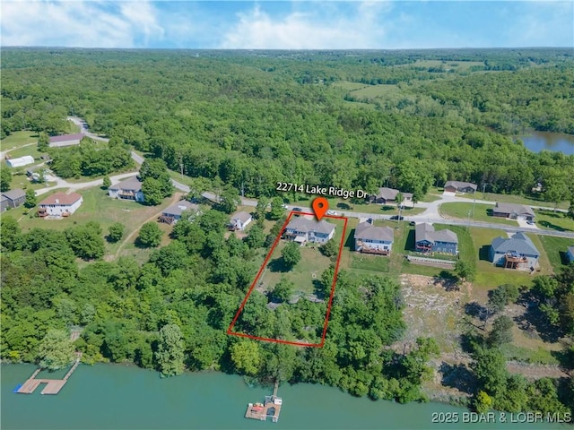 22714 Lake Ridge Dr, Warsaw, MO 65355 - aerial view of property's location featuring a heavily wooded area, property boundaries highlighted, and a nearby body of water