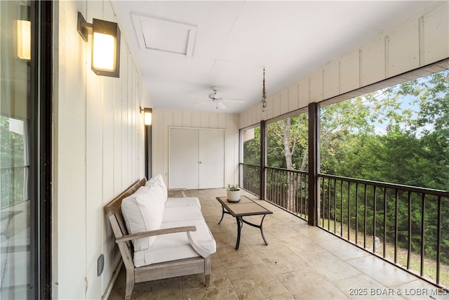 sunroom / solarium with a ceiling fan