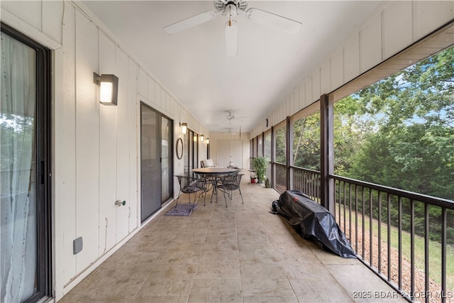 sunroom featuring ceiling fan and outdoor dining area