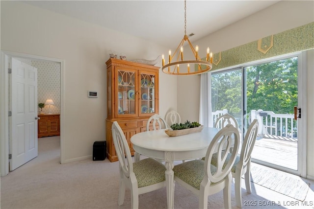 dining area with a chandelier and light carpet