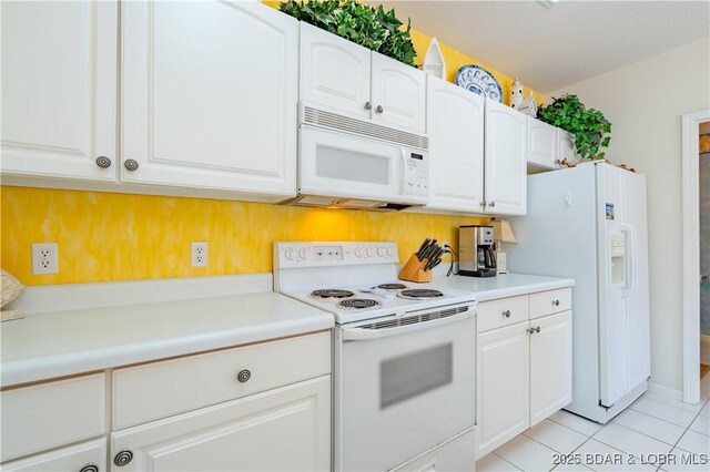 kitchen with white appliances, white cabinetry, light tile patterned floors, and light countertops