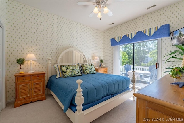 carpeted bedroom featuring wallpapered walls, access to outside, and a ceiling fan