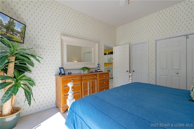 bedroom featuring wallpapered walls, carpet floors, baseboards, and ceiling fan