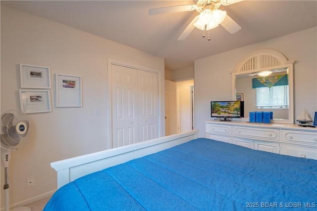 carpeted bedroom with baseboards, ceiling fan, and a closet