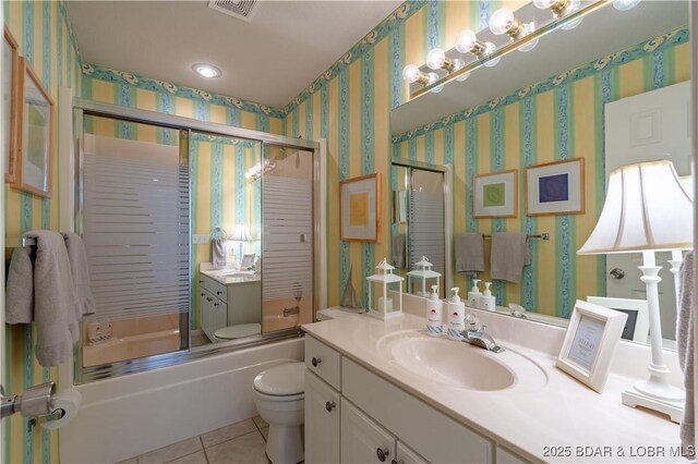 full bathroom featuring tile patterned flooring, toilet, bath / shower combo with glass door, vanity, and wallpapered walls